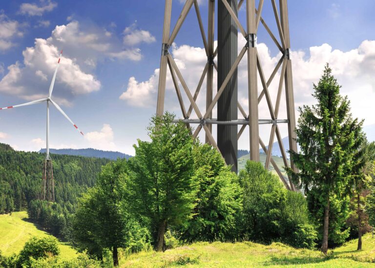Timber hybrid tower of a wind turbine in a green landscape, surrounded by trees and meadows. © HASSLACHER Green Tower